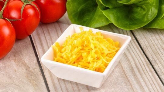 Shredded yellow cheese in the bowl