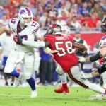 Buffalo Bills quarterback Josh Allen running away from a defensive sack