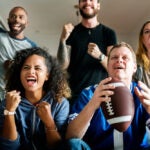 Friends watching on TV and cheering for Super Bowl together