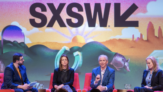 four people onstage for a panel at SXSW