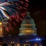 Fireworks burst above Capitol dome building during Fourth of July nighttime celebration in Washington D.C.