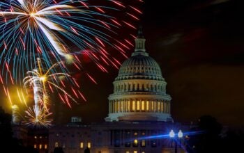 Fireworks burst above Capitol dome building during Fourth of July nighttime celebration in Washington D.C.