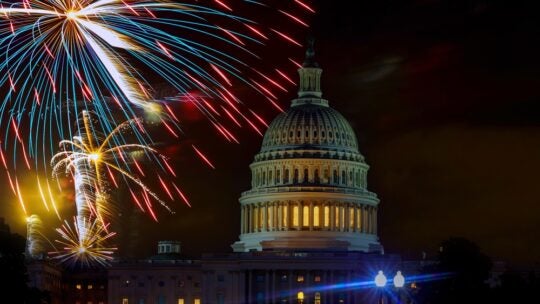 Fireworks burst above Capitol dome building during Fourth of July nighttime celebration in Washington D.C.