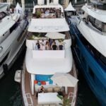 Aerial view of luxury yachts moored in the Old Port during the Cannes Lions International Festival of Creativity. Guests gather on the decks of private vessels, including those chartered for Equativ, to network during the world-renowned advertising and marketing event.
