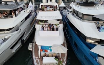Aerial view of luxury yachts moored in the Old Port during the Cannes Lions International Festival of Creativity. Guests gather on the decks of private vessels, including those chartered for Equativ, to network during the world-renowned advertising and marketing event.
