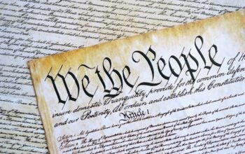 A parchment of the first Constitution of the United States close up. The Bill of Rights as a focus in regards to journalist subpoena by the Department of Justice