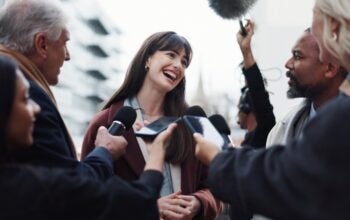 Woman, publicist and press with questions, city and discussion with reporters for interview. publicist outdoors with journalists for campaign updates, news and people with mic