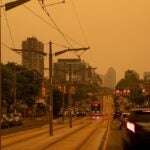 Toronto, Ontario, Canada - July 15 2026: Wildfire Smoke in Toronto shows the city covered in an orange haze as Health Advisory Looms