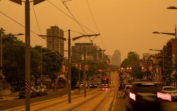 Toronto, Ontario, Canada - July 15 2026: Wildfire Smoke in Toronto shows the city covered in an orange haze as Health Advisory Looms