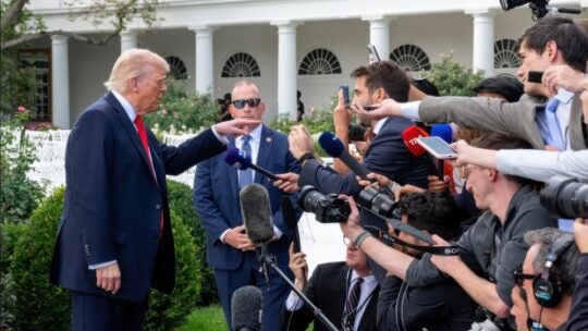 President Donald Trump addressing press before boarding Marine One on the South Lawn of the White House. White House press pool media reporters