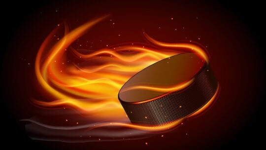 Realistic ice hockey puck in fire on black background
